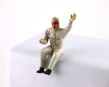 Painted figurine of the sitting driver